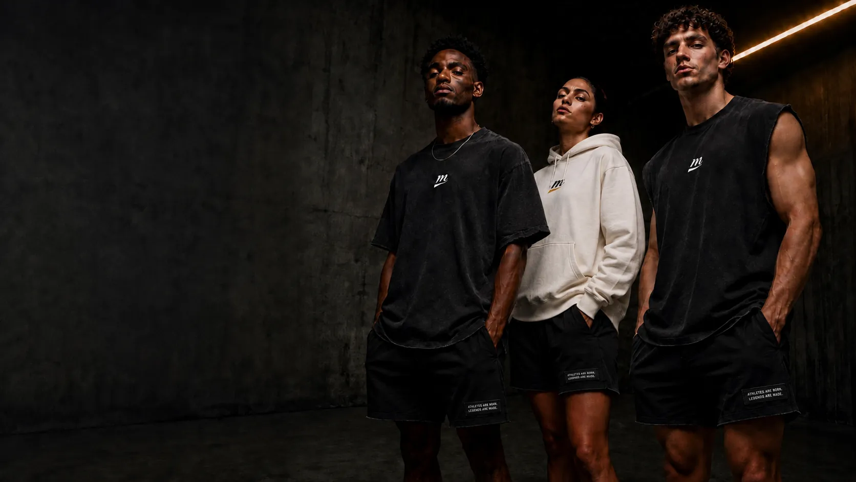 Three athletes in MADE ISSUE washed-black and cream pieces in a concrete tunnel